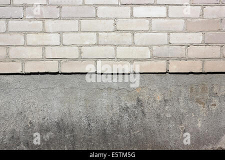 Sharp border between a white silicate bricks and plaster wall texture background Stock Photo
