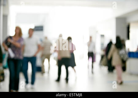 Patients and people walk down a corridor in a  UK NHS hospital on their way to appointments with doctors and nurses. Stock Photo