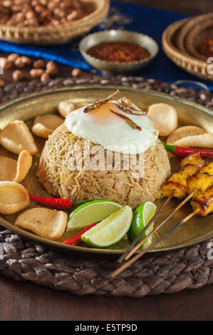 Nasi goreng. Indonesian fried rice with satay. Stock Photo
