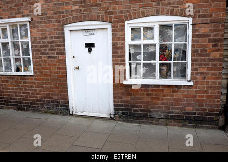 Old white door and window in brick wall house Stock Photo