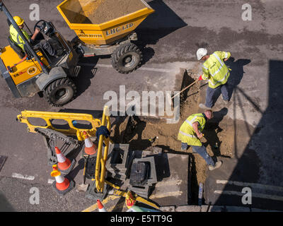 UK Roadworks Repair and replacement of underground water mains pipework by contractors - Amey Stock Photo