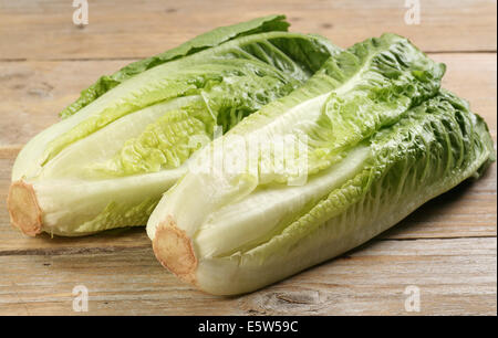 two hearts of romaine lettuce on a rustic wooden board Stock Photo