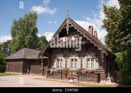 A wooden house with intricate carvings and flower-decked balcony in the Alexandrowka Russian Colony, Potsdam, near Berlin Stock Photo