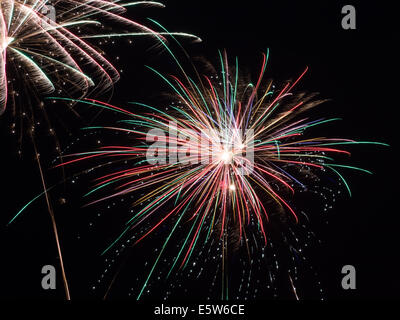 Beautiful multi-colored fireworks exploding in the night sky. Stock Photo