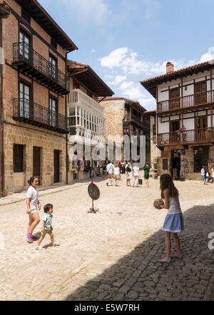 Children playing old town Santillana del Mar, Cantabria, Northern Spain, Europe Stock Photo