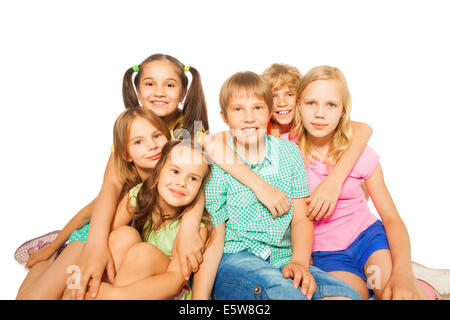 Six smiling children sitting together Stock Photo