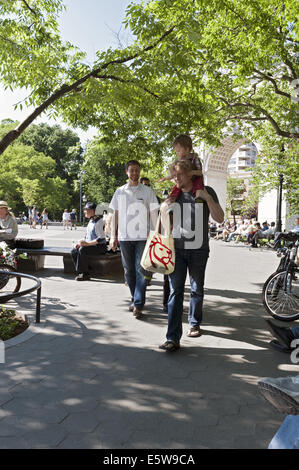 Father giving son piggyback ride at Washington Square park in NYC, 2014. Stock Photo
