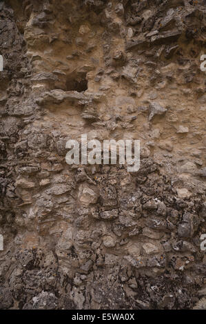 medieval bricks and mortar part of a solid castle wall showing eroded hole where a first floor would have been Stock Photo