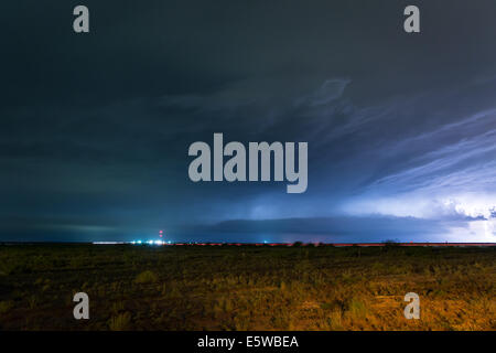 Lightning strikes the ground and flashes across the night sky Stock Photo