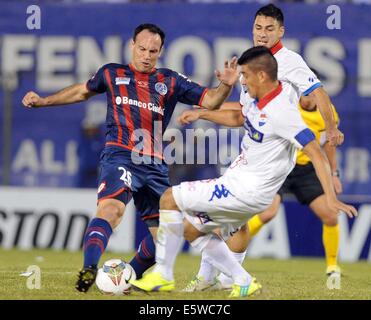 Asuncion, Paraguay. 6th Aug, 2014. Nacional's Jose Caceres (R) vies for the ball with Mauro Matos (L) of San Lorenzo, during their first-leg final match of the 2014 Libertadores Cup, held at Defensores del Chaco Stadium, in Asuncion, Paraguay, on Aug. 6, 2014. Credit:  Jose Romero/TELAM/Xinhua/Alamy Live News Stock Photo