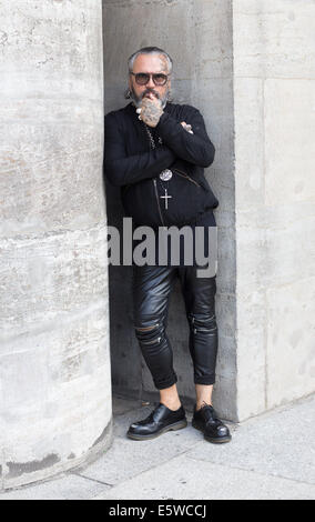 Berlin, Germany. 05th Aug, 2014. Berghain doorman Sven Marquardt poses at Volksbuehne theater in Berlin, Germany, 05 August 2014. Berlin cult club Berghain celebrates its ten year anniversary with an exhibition. Part of the exhibition are photographs of the legendary and feared doorman. Photo: Joerg Carstensen/dpa/Alamy Live News Stock Photo