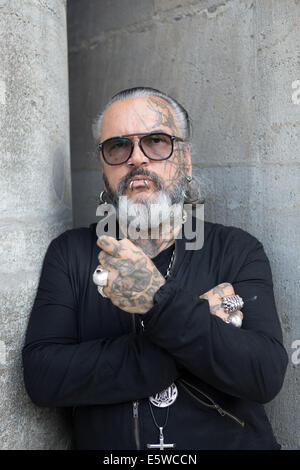 Berlin, Germany. 05th Aug, 2014. Berghain doorman Sven Marquardt poses at Volksbuehne theater in Berlin, Germany, 05 August 2014. Berlin cult club Berghain celebrates its ten year anniversary with an exhibition. Part of the exhibition are photographs of the legendary and feared doorman. Photo: Joerg Carstensen/dpa/Alamy Live News Stock Photo