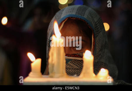 Pakistan. 6th Aug, 2014. Women Activists of Pakistan Awami Tehreek (PAT), a follower of Allama Tahir ul Qadri, who promotes social and religious harmony and is known also for working on democratic political values in Pakistan, along with members of the Pakistan Muslim League (Q) hold candlelight vigil in memory of innocent people who lost their lives in the model town last June 17, 2014 Lahore. There were eight (8) people killed in the clash of which 2 were women. Credit:  Rana Sajid Hussain/Pacific Press/Alamy Live News Stock Photo