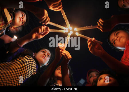 Pakistan. 6th Aug, 2014. Women Activists of Pakistan Awami Tehreek (PAT), a follower of Allama Tahir ul Qadri, who promotes social and religious harmony and is known also for working on democratic political values in Pakistan, along with members of the Pakistan Muslim League (Q) hold candlelight vigil in memory of innocent people who lost their lives in the model town last June 17, 2014 Lahore. There were eight (8) people killed in the clash of which 2 were women. Credit:  Rana Sajid Hussain/Pacific Press/Alamy Live News Stock Photo