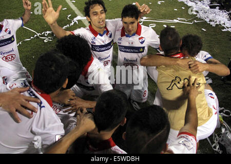 Asuncion, Paraguay. 6th Aug, 2014. Nacional's players celebrate after the first-leg final match of the 2014 Libertadores Cup against San Lorenzo at Defensores del Chaco Stadium, in Asuncion, Paraguay, on Aug. 6, 2014. Credit:  Str/Xinhua/Alamy Live News Stock Photo
