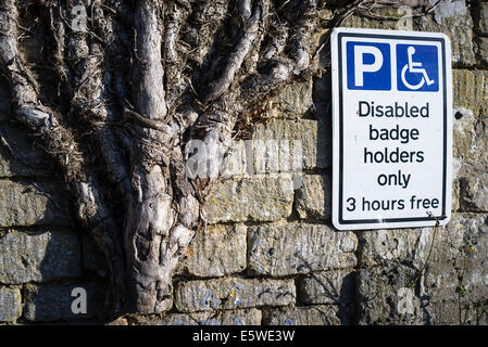 Disabled parking sign on a wall Stock Photo - Alamy