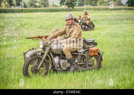 STARY TEKOV, SLOVAKIA - JULY 26,2014:  Soviet soldiers riding sidecars to attack germans during reenactment of World War II Stock Photo