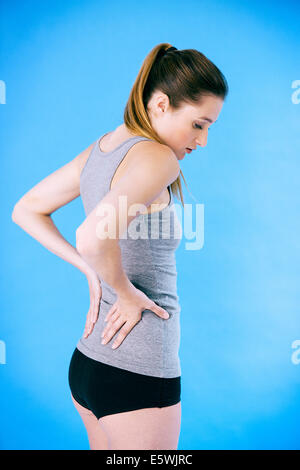 Lower back pain in a woman Stock Photo