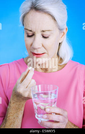 Elderly person taking medication Stock Photo