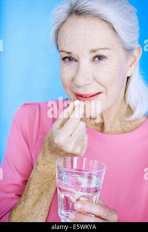 Elderly person taking medication Stock Photo
