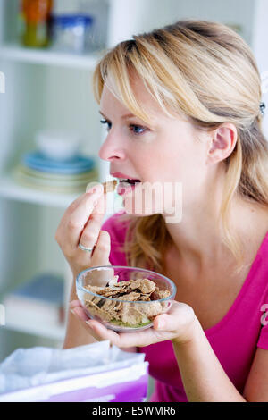 Woman eating breakfast Stock Photo