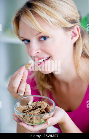 Woman eating breakfast Stock Photo