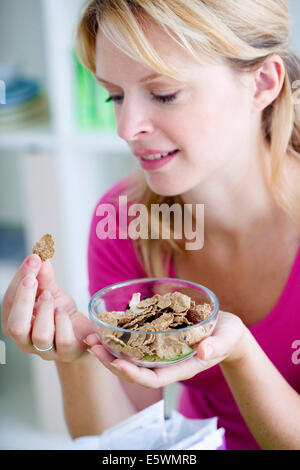 Woman eating breakfast Stock Photo