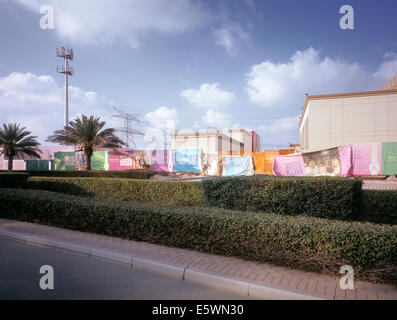 Fence with advertising at a development area in Dubai, United Arab Emirates Stock Photo