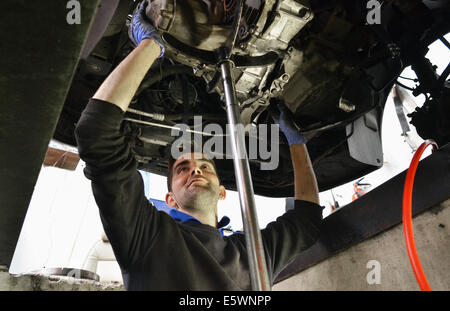 Mechanic checking car undercarriage Stock Photo