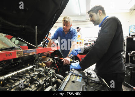Mechanic checking car engine Stock Photo