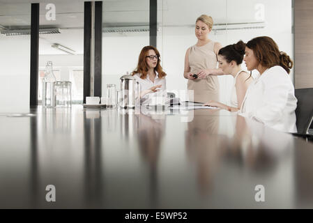 Four businesswomen meeting in conference room Stock Photo