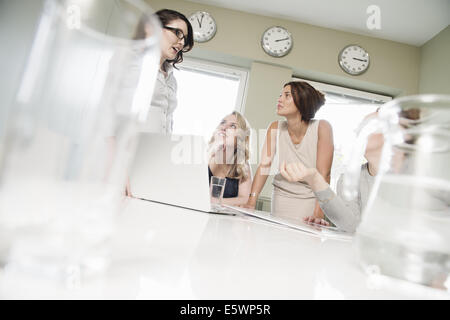 Four businesswomen meeting in conference room Stock Photo