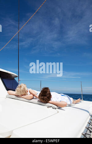 Two brothers sunbathing on catamaran near Fuerteventura, Spain Stock Photo