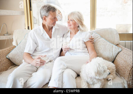 Couple celebrating in hotel room Stock Photo