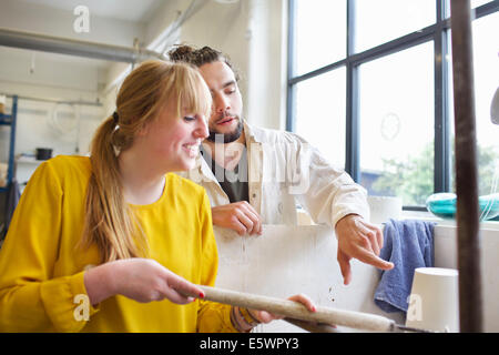 Potter couple working in ceramic workshop Stock Photo
