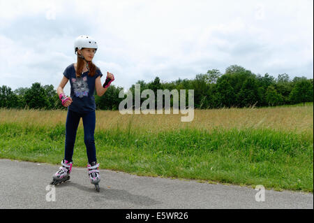 Girl rollerblading in park Stock Photo