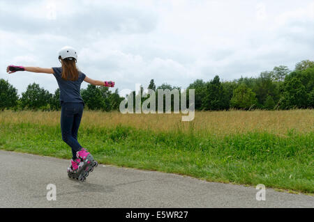 Rear view of girl rollerblading in park Stock Photo