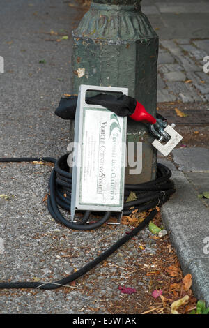 Traffic data collection device chained to the base of a lamp post at the side of a UK road Stock Photo