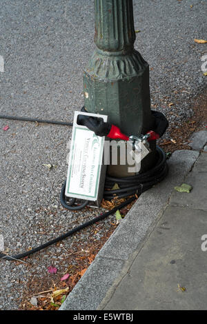 Traffic data collection device chained to the base of a lamp post at the side of a UK road Stock Photo