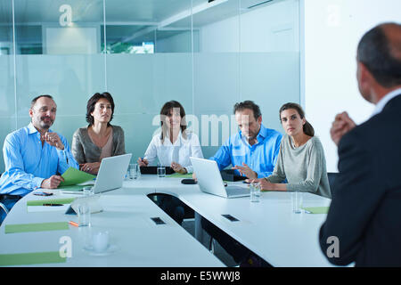 Business team interviewing candidate at boardroom table Stock Photo