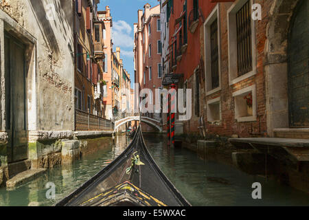 Close up of part gondola with canal bridge in distance, Venice, Veneto, Italy Stock Photo
