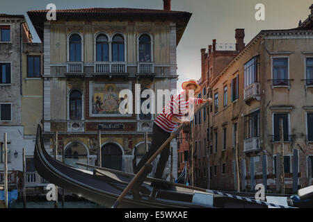 Gondolier on Grand canal, Venice, Veneto, Italy Stock Photo