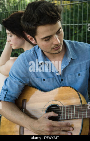 Young couple playing the guitar Stock Photo - Alamy