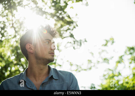 Portrait of serious young man in park Stock Photo