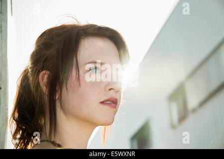 Portrait of sultry young woman on street Stock Photo
