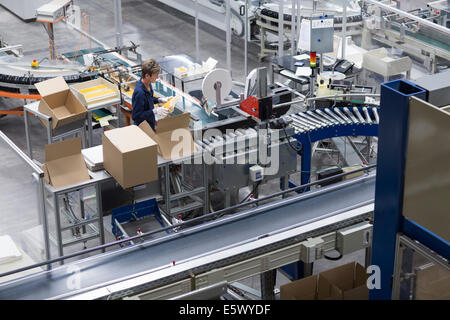 Mature woman working in paper packaging factory Stock Photo