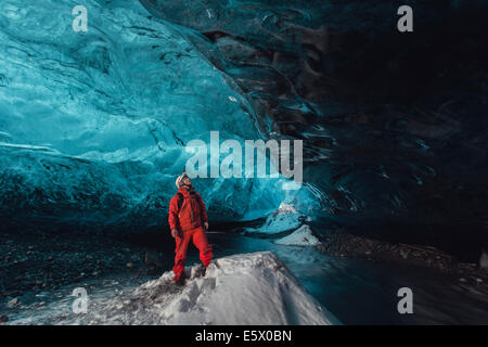Man gazing upward in ice cave, Vatnajokull Glacier, Vatnajokull National Park, Iceland Stock Photo
