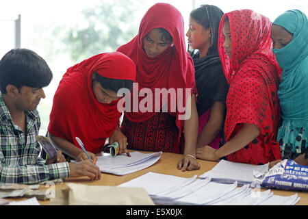Dhaka, Bangladesh. 7th Aug, 2014. Garments worker of Tuba Group were seen at the BGMEA office on Thursday collecting their partial dues.Worker get 2 month Salary & wages, and Eid festival bonus. Credit:  Zakir Hossain Chowdhury/ZUMA Wire/Alamy Live News Stock Photo