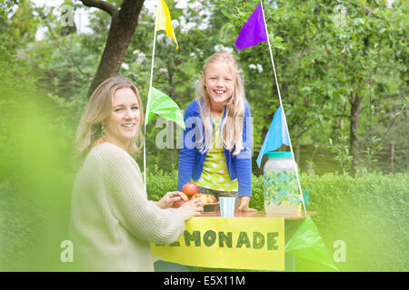 Mother buying lemonade from daughter's stand Stock Photo