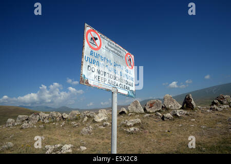 Sisian, Armenia. 27th June, 2014. A sign in Armenian and English at the prehistoric archaeological site Zorats Karer asks visitors no to touch the stones and to keep the site clean near Sisian, Armenia, 27 June 2014. The site served as a necropolis from the Middle Bronze Age to the Iron Age. Photo: Jens Kalaene -NO WIRE SERVICE-/dpa/Alamy Live News Stock Photo